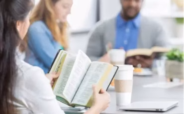 People reading the Bible together during Open Heaven Wednesday Bible Study in Merrimac.